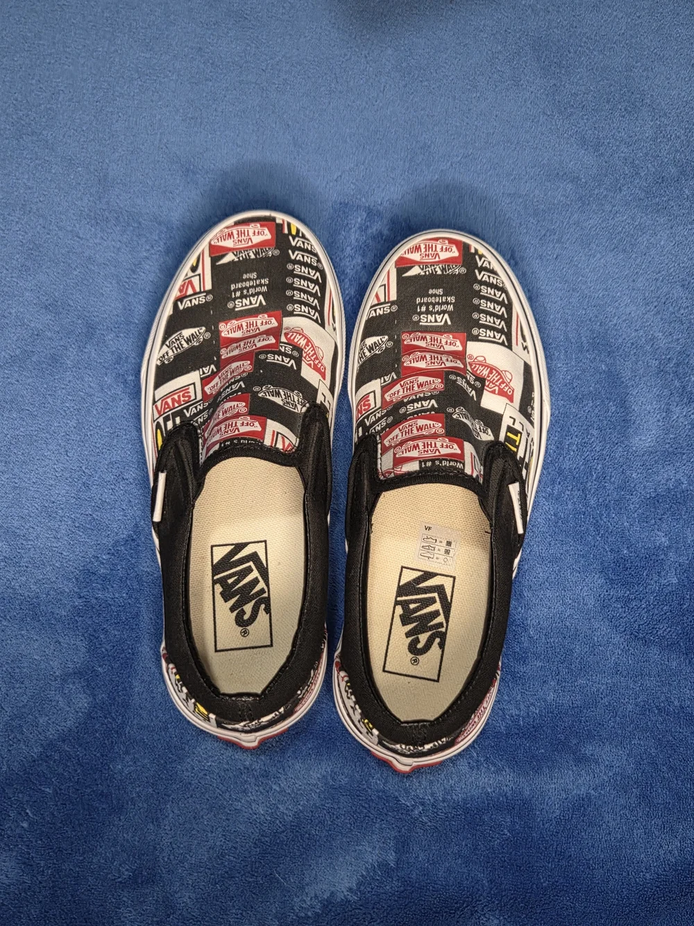 Vans Slip-On Skate Shoes in Black & White with Red Logo Print
